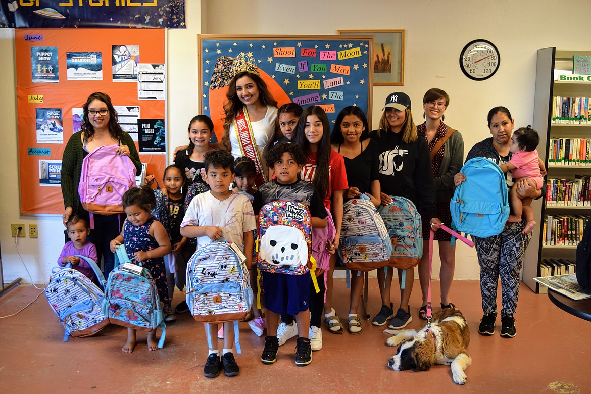 Charles H. Featherstone/Sun Tribune
Shree Saini donated backpacks to excited children at the George Public Library last week.