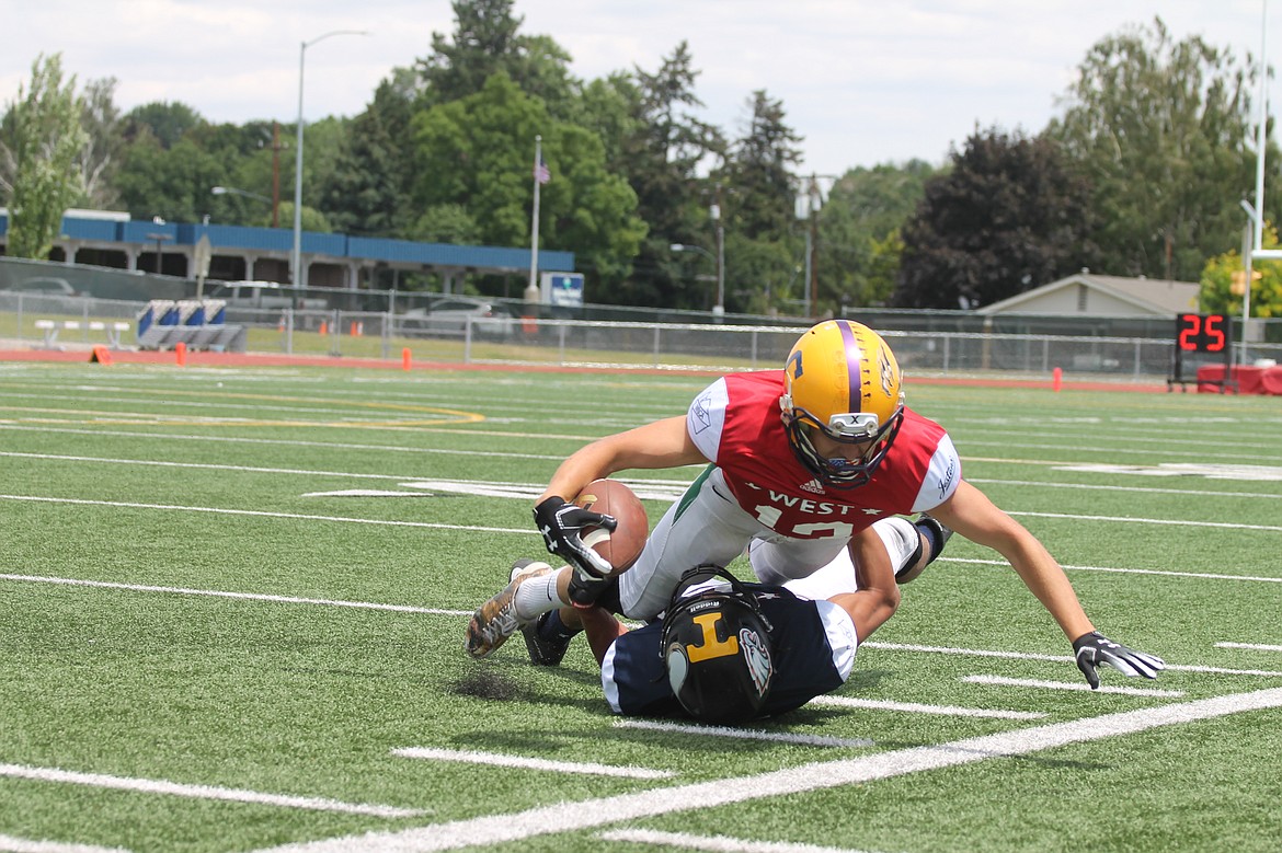 Casey McCarthy/ Columbia Basin Herald Royal's Angel Farias brings down the West side receiver in the 25th annual Earl Barden Classic on Saturday.