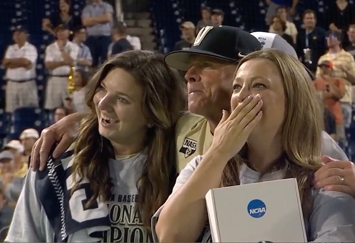 In this screen grab from ESPN, Vanderbilt baseball administrative assistant Casey Stangel, left; Vanderbilt baseball coach Tim Corbin and Vanderbilt athletic trainer Tracy Campbell watch the celebration after the Commodores won the College World Series on Wednesday in Omaha, Neb.