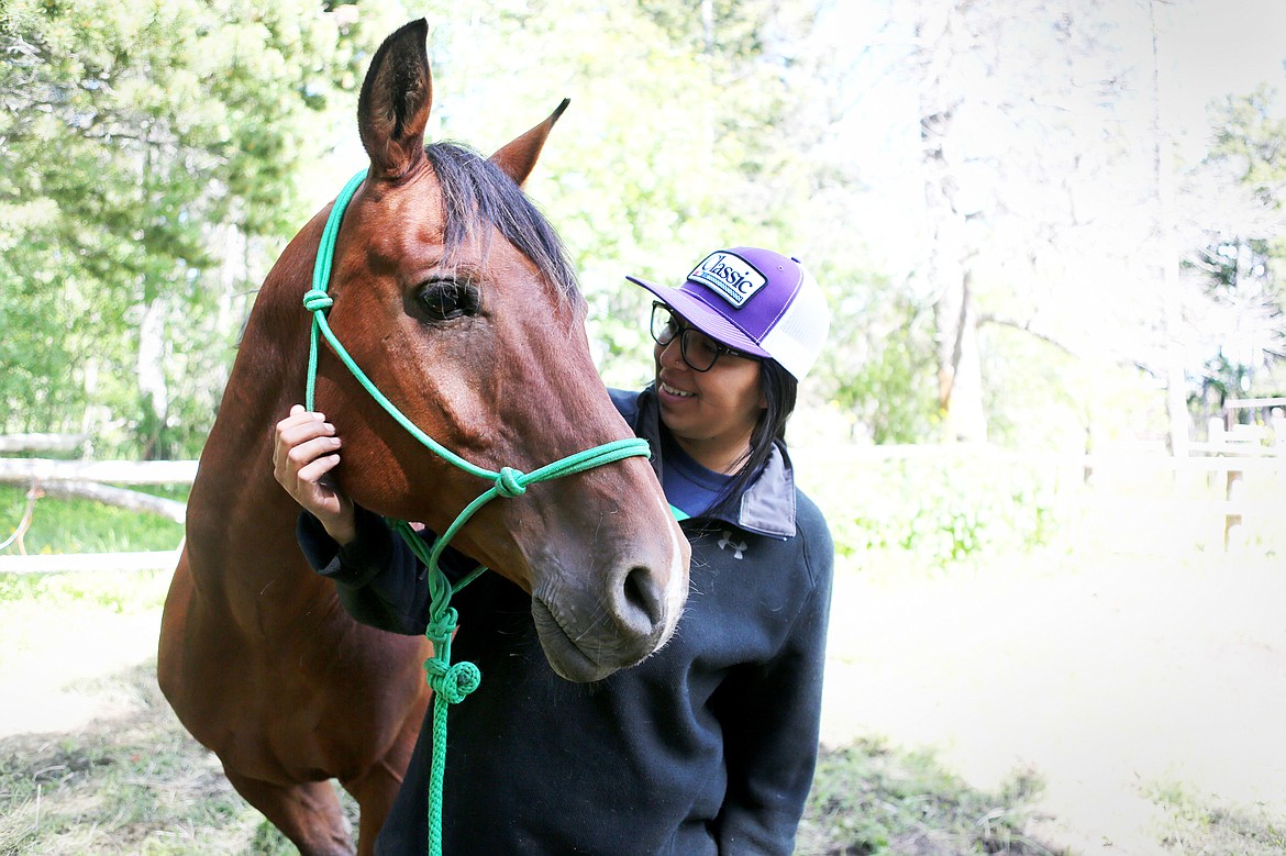 Shaylea Tatsey, 25, is pictured with her horse Houdini at Glacier Gateway Trailrides in East Glacier Park. (Mackenzie Reiss/Daily Inter Lake)