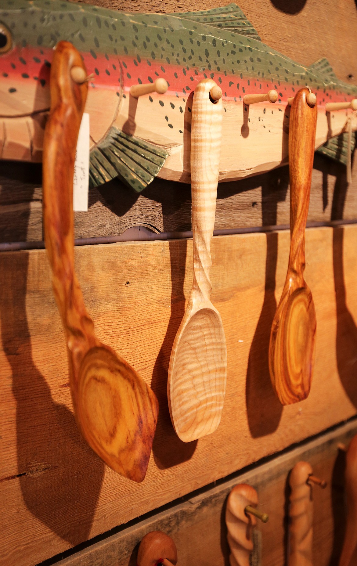 Sturdy wooden spoons are displayed on a wall inside the Spiral Spoon.