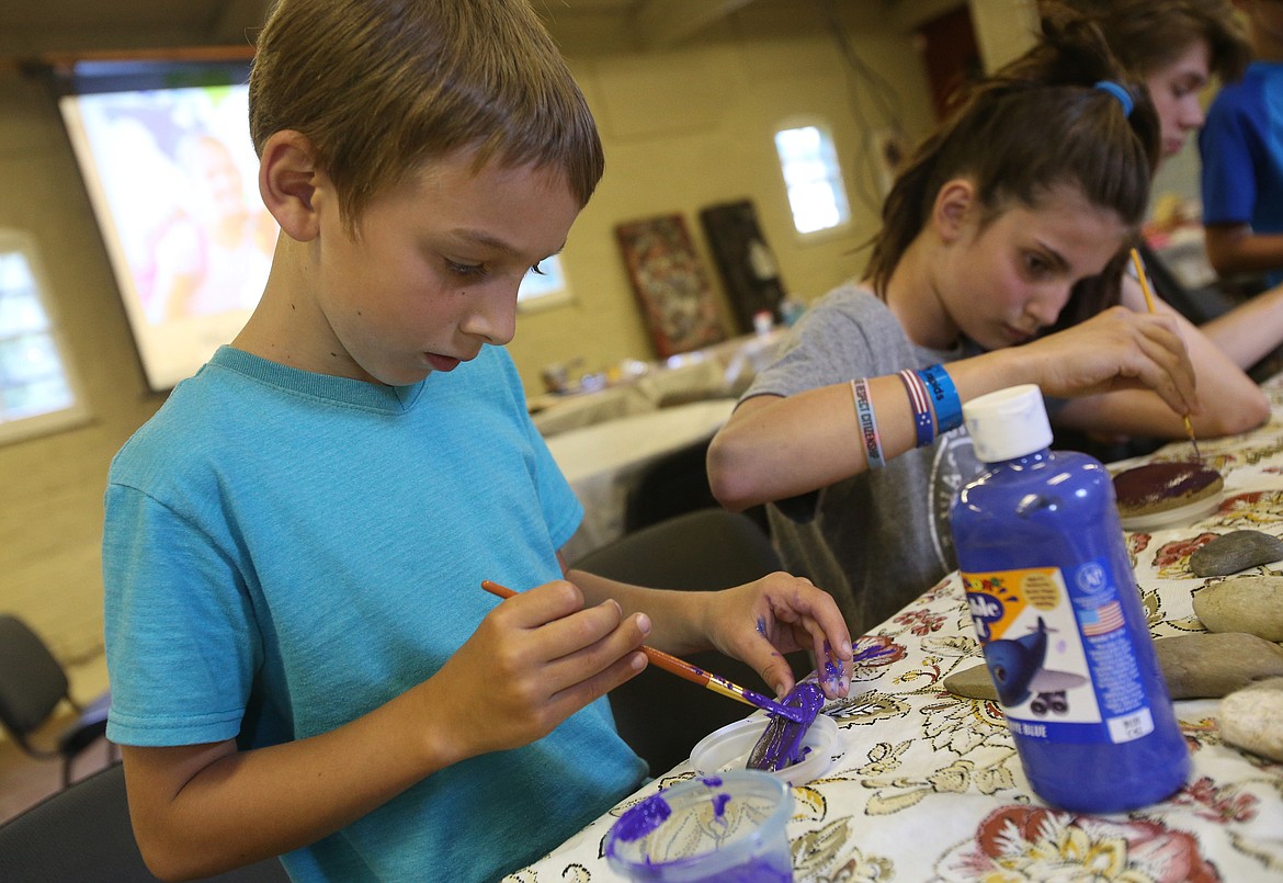 LOREN BENOIT/Press
Nolan Shaw, 8, and Piper Giovannelli, 10, paint rocks during a multicultural camp Monday at the Human Rights Education Institute. Campers played games and learned about arts and culture from Eastern Asia, Pacific Asia, Latin America, Australia, Africa, and Native Americans.