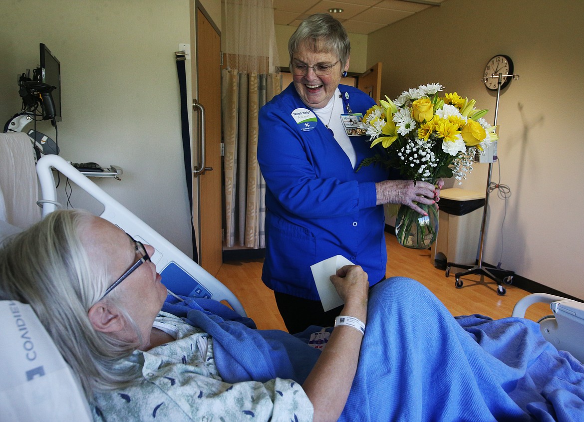 Kootenai Health volunteer Susan Riess delivers flowers to Rita Langford, of Tulsa, Oklahoma. The get well flowers were from a family friend of Riess&#146; husband in Florida. (LOREN BENOIT/Press)