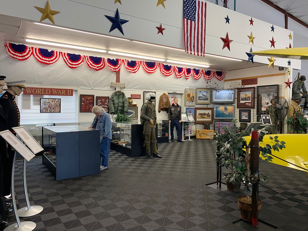 Visitor Sherry Asper examines the WWII display (SHOLEH PATRICK/Press).