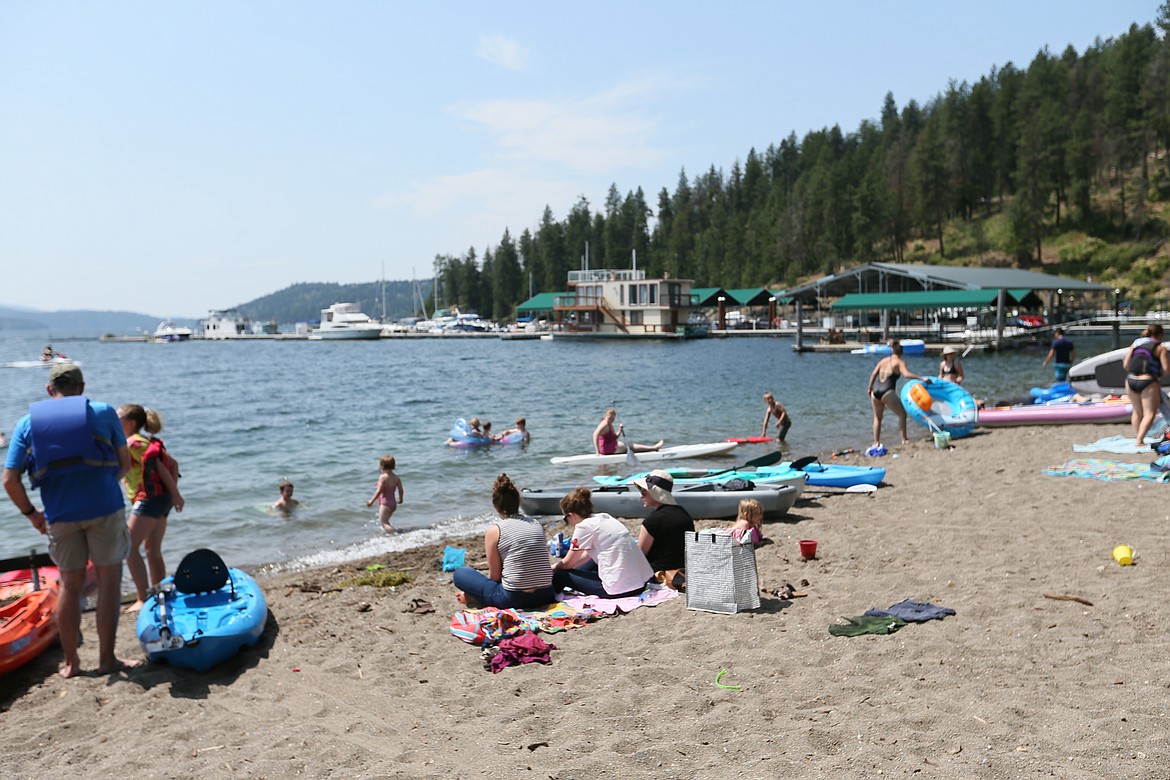 Peaceful people enjoy the sun and sand on Sanders Beach Saturday.