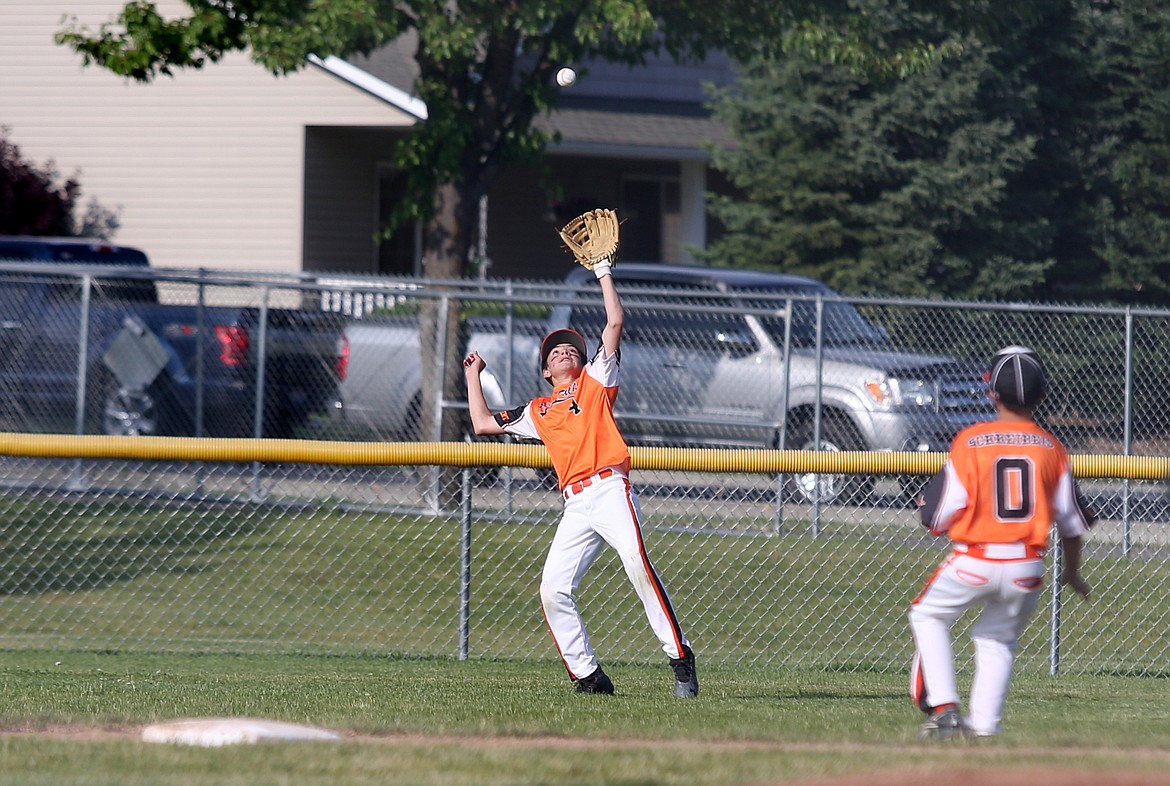 LOREN BENOIT/Press
Post Falls center fielder Troy Eckstein battles the evening sun as he tracks a fly ball in a Little League Majors District 1 tournament game against Coeur d&#146;Alene on Friday at Canfield Sports Complex in Coeur d&#146;Alene.