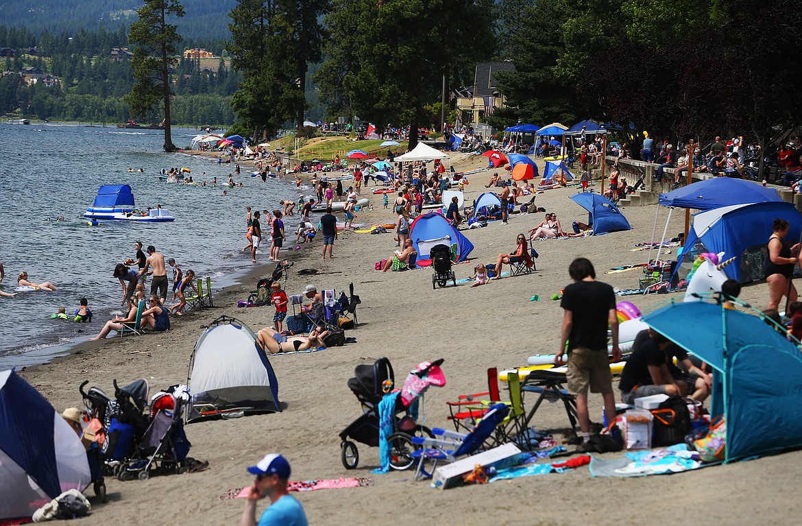 Locals and tourists soak sun rays early Thursday afternoon at City Beach during Fourth of July. (LOREN BENOIT/Press)