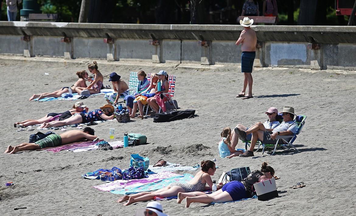 LOREN BENOIT/Press
Beach goers bask in the afternoon sun at City Beach on Tuesday. There is only a slight chance of rain over this holiday weekend.