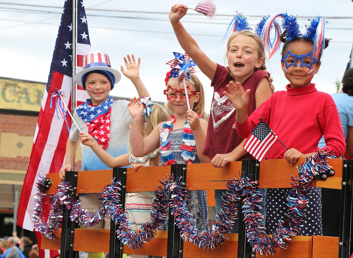 A group of youngsters celebrate the Fourth as they ride a float in a past Fourth of July Grand Parade.