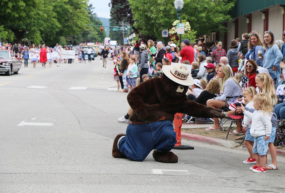 (Photo by CAROLINE LOBSINGER)Smokey Bear says hello to a trio of young fans as the Sandpoint Lions' Grand Parade gets under way in Sandpoint on Thursday.