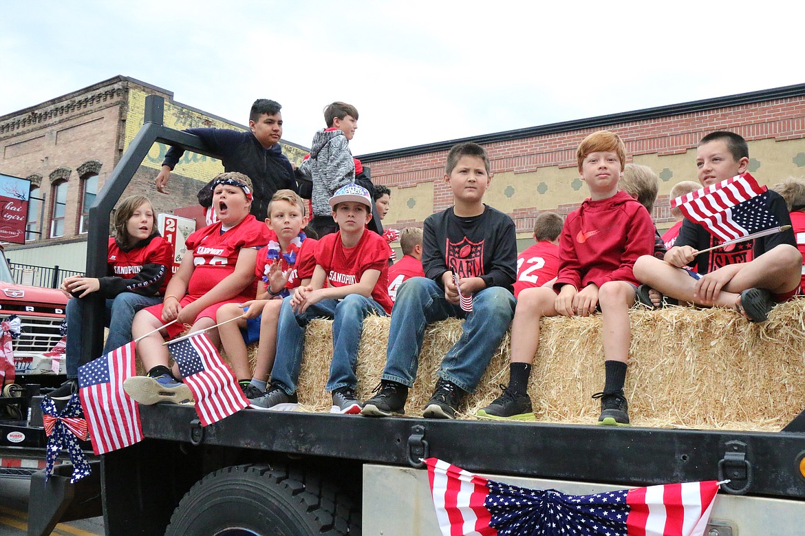 (Photo by CAROLINE LOBSINGER)Young Sandpoint football players ride on a float during Thursday's Grand Parade.