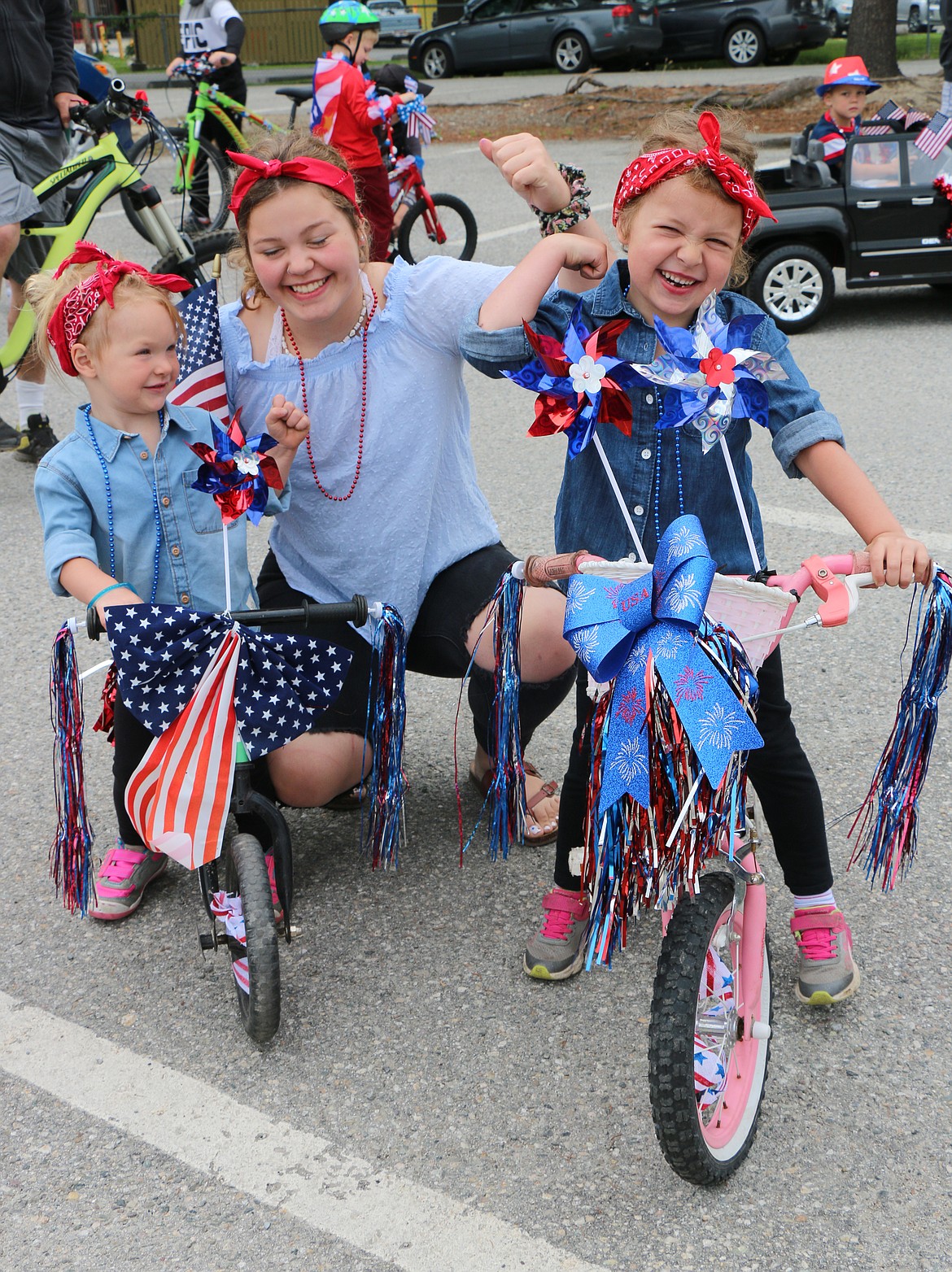 (Photo by CAROLINE LOBSINGER)
Bailey Kleffner, Katie Stewart and Ashley Kleffner demonstrate their Rosie the Riveter style as they wait for the start of the Sandpoint Lions&#146; Fourth of July Kids Parade on Thursday.