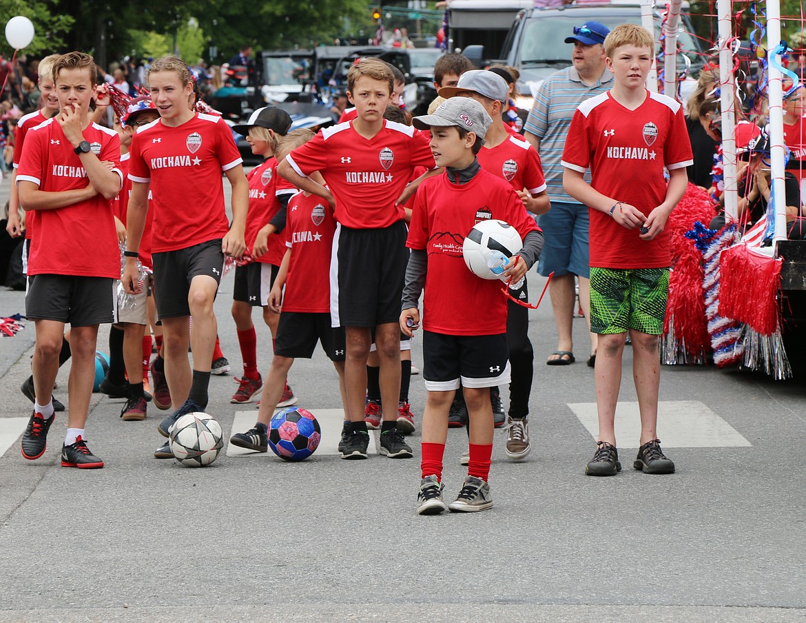 (Photo by CAROLINE LOBSINGER)Young Sandpoint Strikers soccer players manuever soccer balls down Church Street during the Sandpoint Lions' Grand Parade on Thursday.