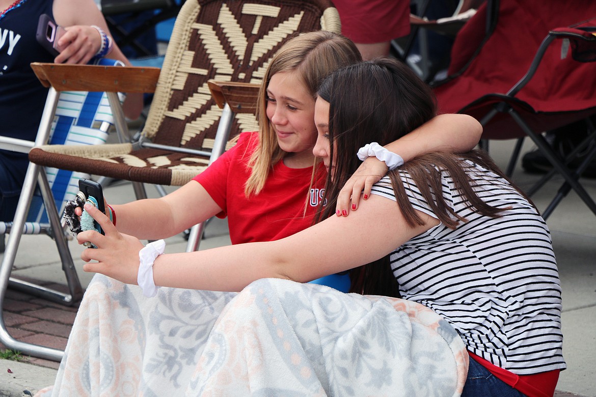 (Photo by CAROLINE LOBSINGER)A pair take a selfie as they wait for the start of the Sandpoint Lions' Fourth of July Grand Parade on Thursday.