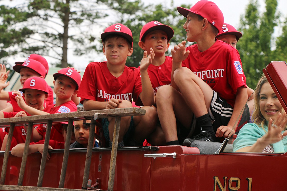 (Photo by CAROLINE LOBSINGER)Young Sandpoint baseball players ride atop a float in the Sandpoint Lions' Fourth of July Grand Parade on Thursday.