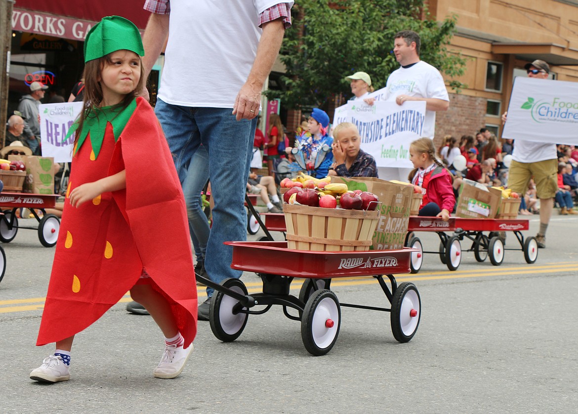 (Photo by CAROLINE LOBSINGER)A young supporter of Food For Our Children gets into the spirit as she dresses as a strawberry to take part in the Sandpoint Lions' Grand Parade on Thursday during the Fourth of July.