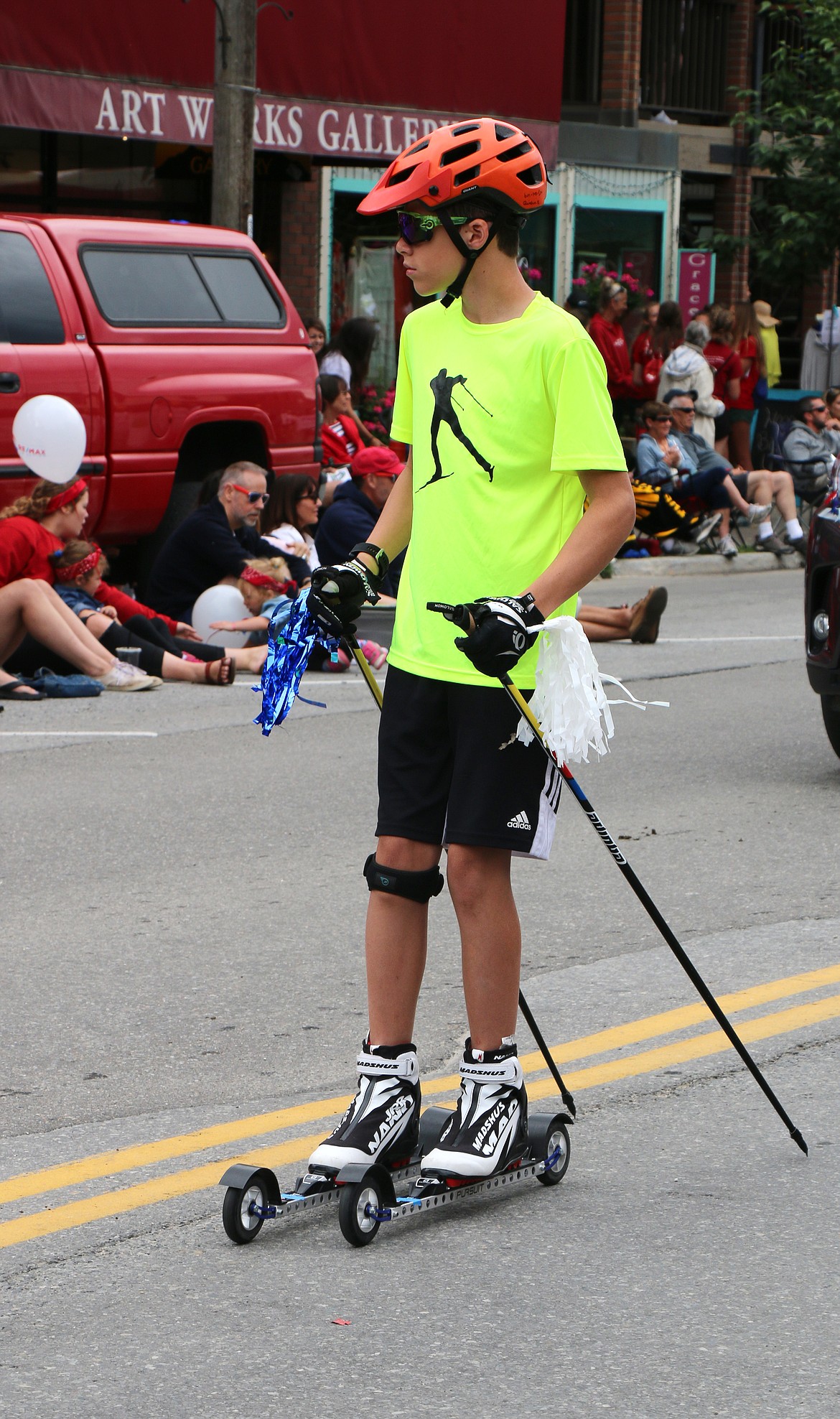 (Photo by CAROLINE LOBSINGER)A Grand Parade participant makes his way down First Avenue on the Fourth of July.