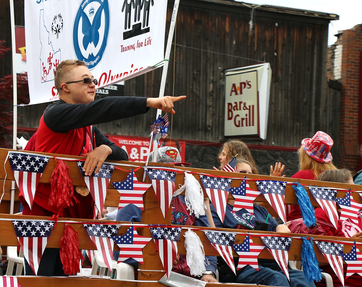 (Photo by CAROLINE LOBSINGER)A member of the local Special Olympics team catches the attention of a friend as he takes part in the Grand Parade, held Thursday by the Sandpoint Lions Club.