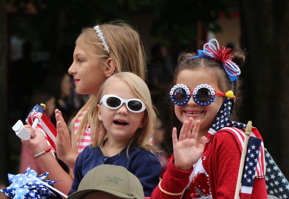 A young parade trio has fun as they take part in a past Grand Parade on the Fourth of July.