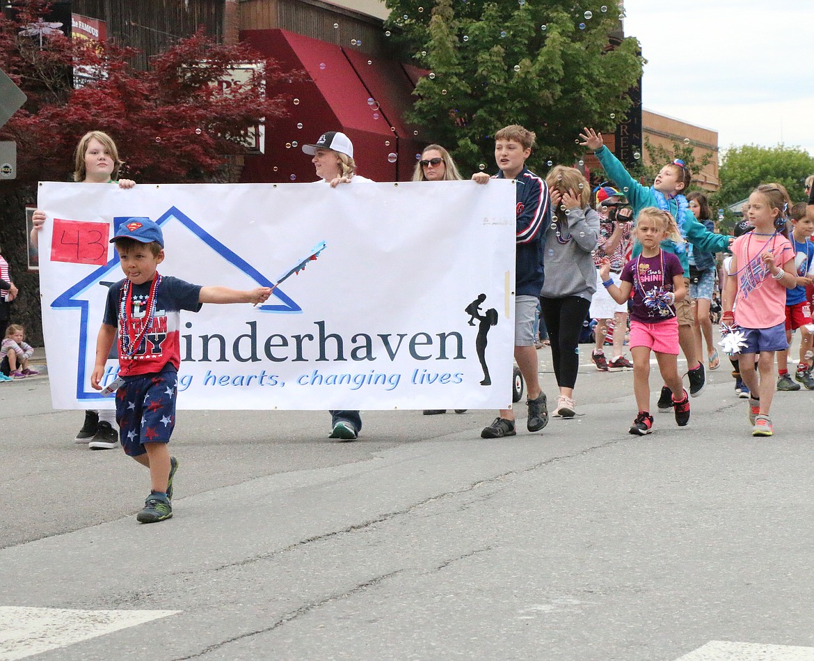 (Photo by CAROLINE LOBSINGER)A youngster takes part in Kinderhaven's Fourth of July parade group during Thursday's Grand Parade.