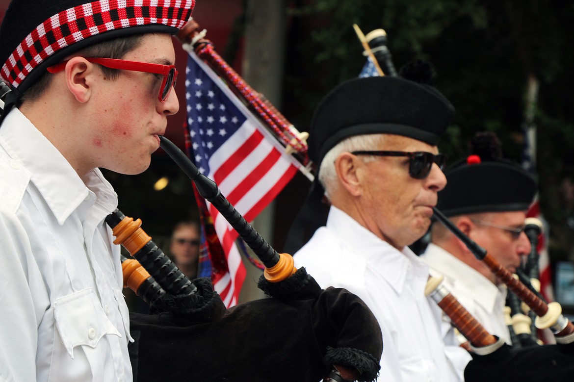 (Photo by CAROLINE LOBSINGER)Albeni Falls Pipes &amp; Drums members make their way down First Avenue during the Fourth of July Grand Parade.