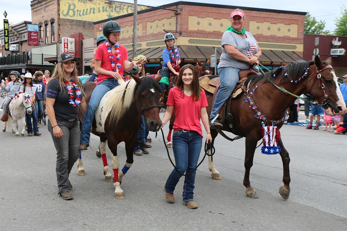 (Photo by CAROLINE LOBSINGER)Young 4-H members make their way down First Avenue during the Sandpoint Lions' Fourth of July Grand Parade on Thursday.