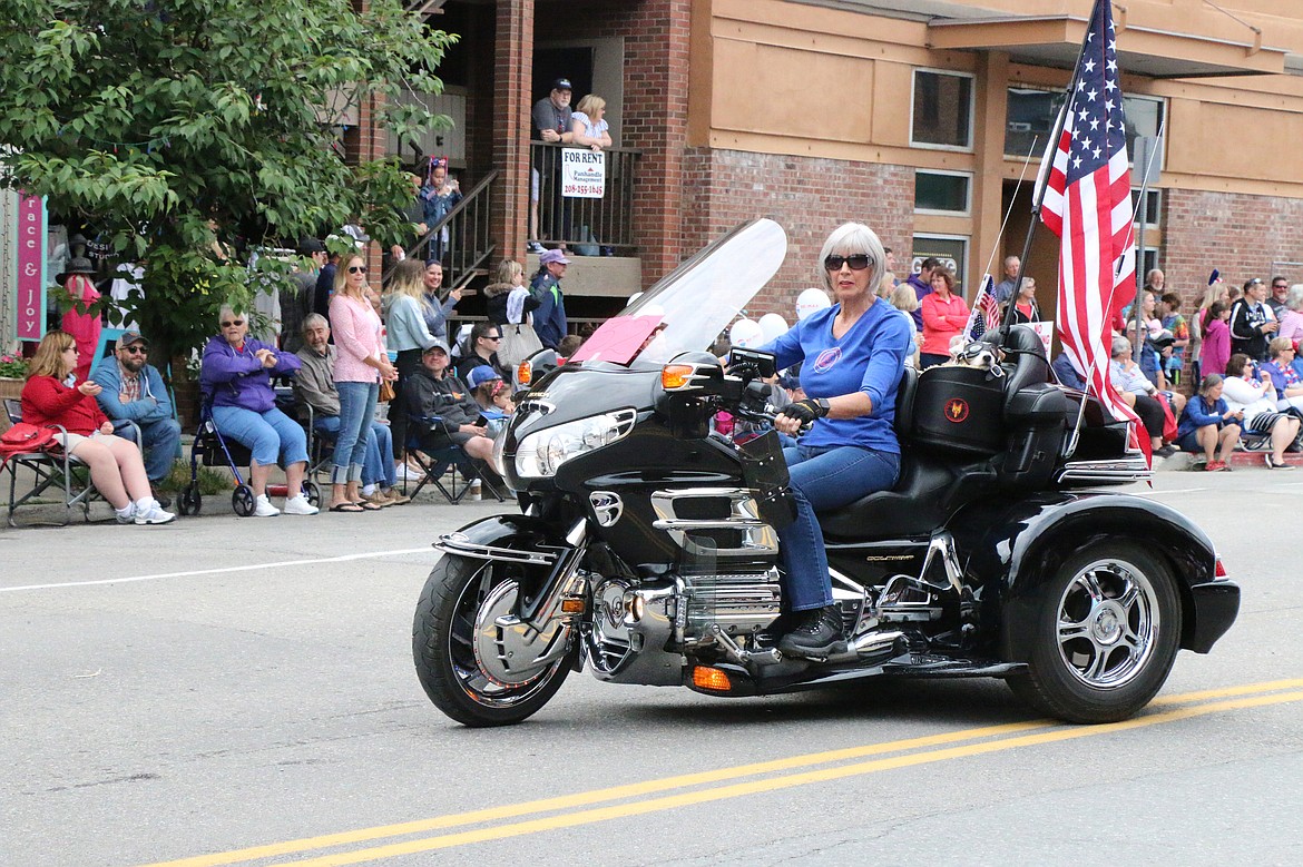 (Photo by CAROLINE LOBSINGER)A Community Assistance League member makes her way down First Avenue on a Honda Goldwing trike during the Sandpoint Lions' Fourth of July Grand Parade on Thursday.