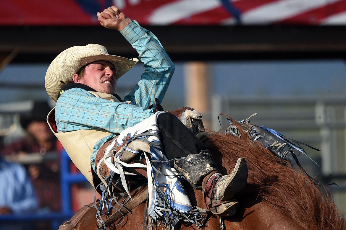 Shawn Perkins, of Bozeman, hangs on during the Bareback Riding event at the Bigfork Rodeo on Friday. (Casey Kreider/Daily Inter Lake)