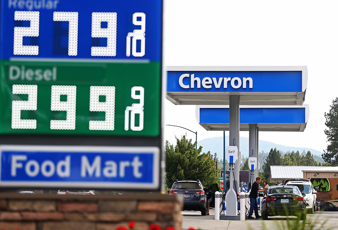 Customers fill up their vehicles with gas at the Northwest Boulevard Chevron Tuesday morning. (LOREN BENOIT/Press)