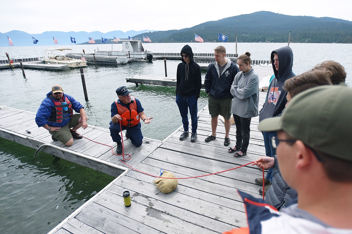 Luke Venters, left, and Kyle Boyce, U.S. Coast Guard Auxiliary Flotilla Commander, demonstrate sailing knots to a group of Boy Scouts and Venture Scouts.
