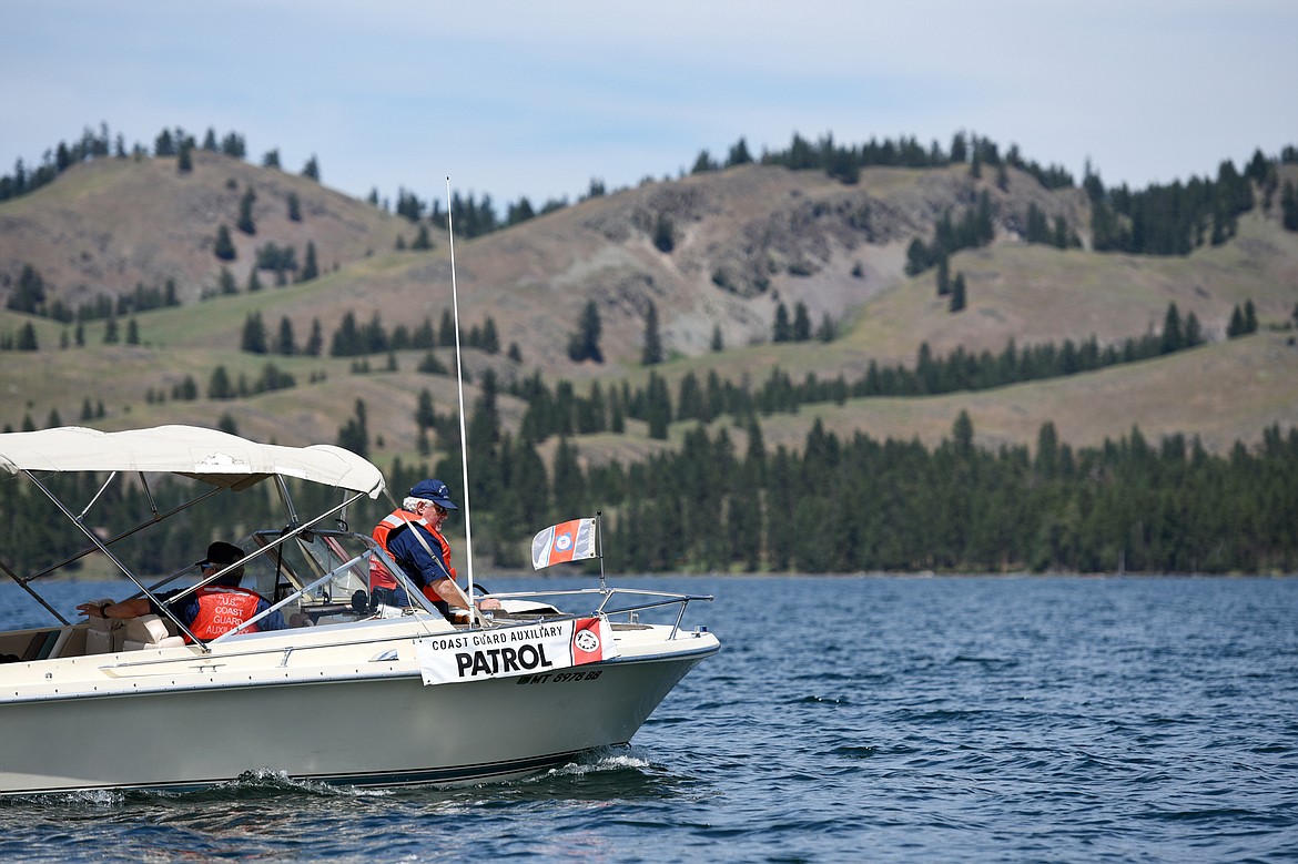 Kyle Boyce, left, U.S. Coast Guard Auxiliary Flotilla Commander, and Chris Roberts, Flotilla Staff Officer, patrol during a demonstration on Flathead Lake near Big Arm on Tuesday, June 25. In the background is Wild Horse Island. (Casey Kreider/Daily Inter Lake)