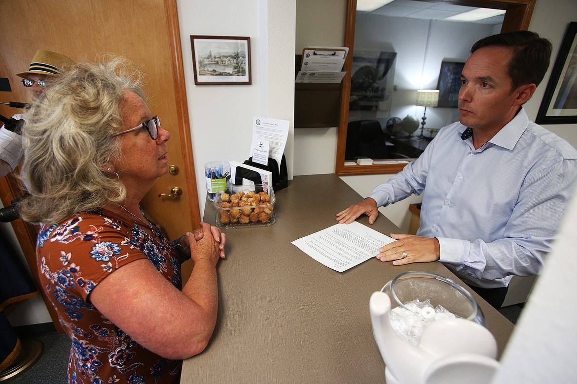 Sid Smith, Coeur d&#146;Alene-based communications coordinator for Sen. Jim Risch, accepts a letter from Coeur d&#146;Alene resident Kristi Milan detailing the concerns of conditions for migrant children at the border. (LOREN BENOIT/Press)