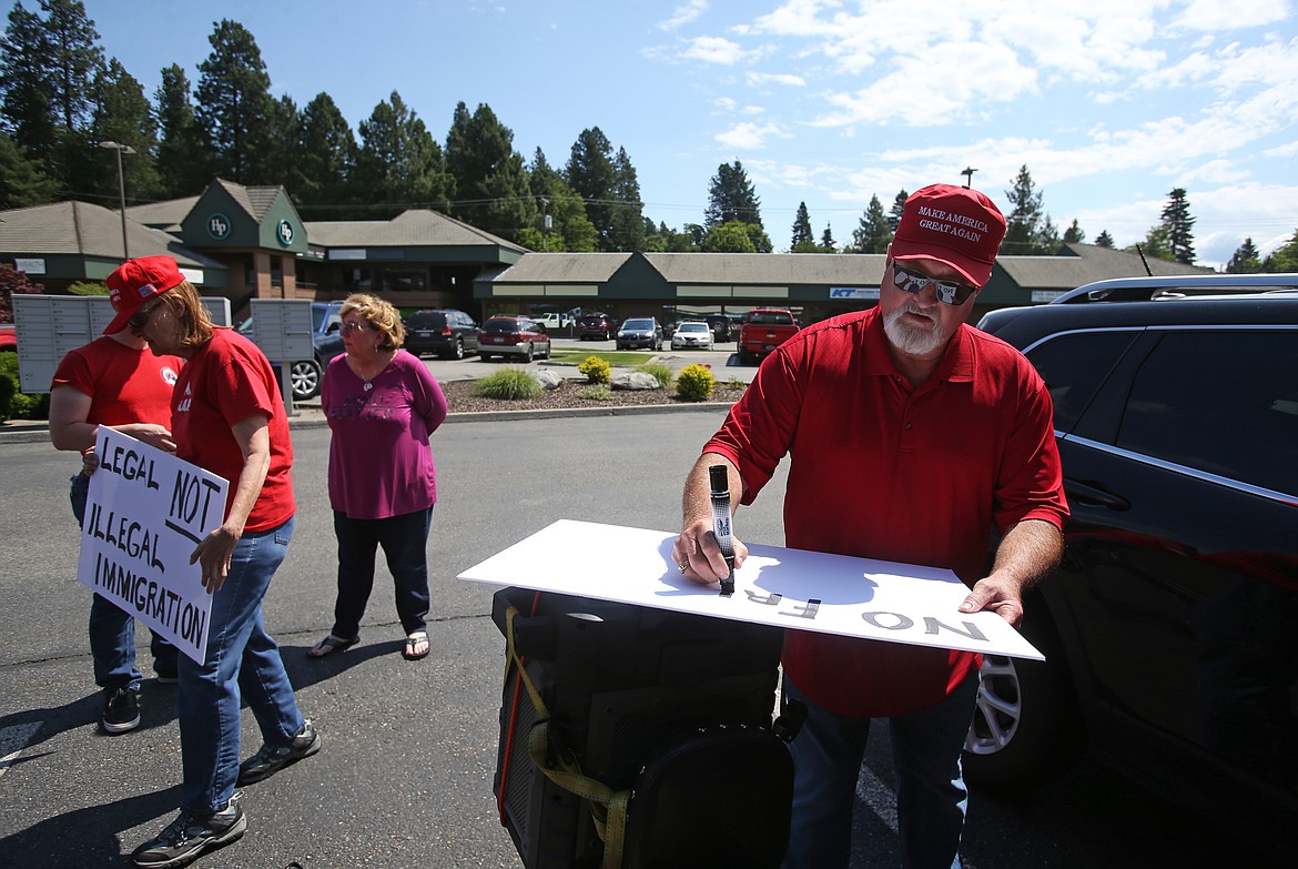 Jeff Tyler makes a sign prior to a MoveOn counter rally in front of the offices of Sens. Mike Crapo and Jim Risch in Coeur d&#146;Alene on Tuesday.