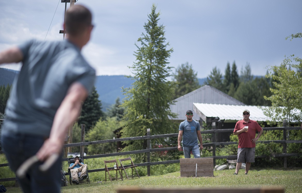 Competitors take turns playing horseshoes and drinking beer during a horseshoe tournament, Saturday at the Yaak River Mercantile and Tavern. (Luke Hollister/The Western News)