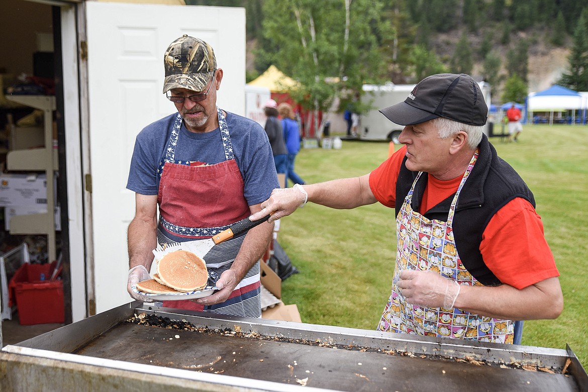 Roy Richardson loads up a plate of pancakes for Rick Blomdauhl as breakfast is served at Roosevelt Park during Troy&#146;s Old Fashioned 4th of July Thursday. (Ben Kibbey/The Western News)