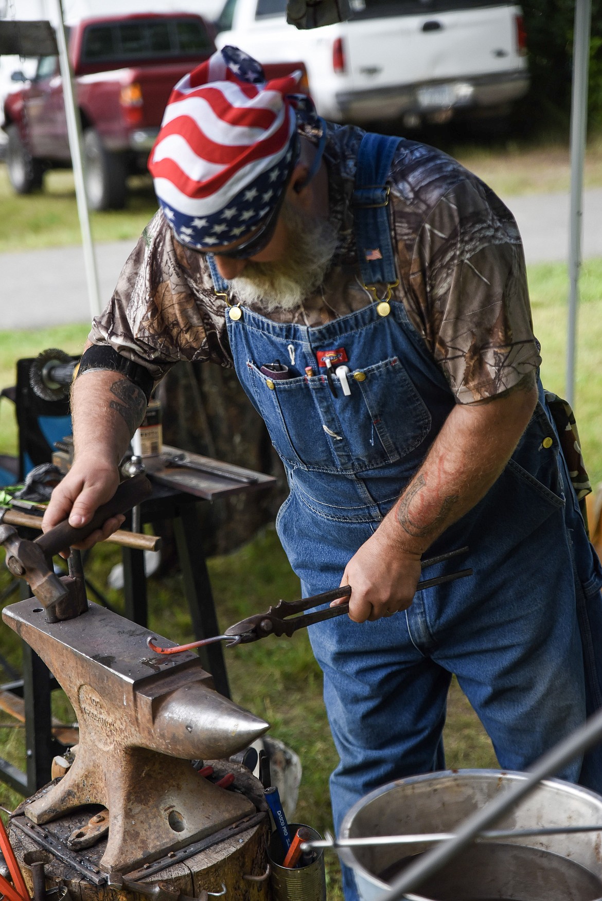 Chris Miller, Bull Valley Forge, demonstrates forging an iron hook in Roosevelt Park during Troy&#146;s Old Fashioned 4th of July Thursday. (Ben Kibbey/The Western News)
