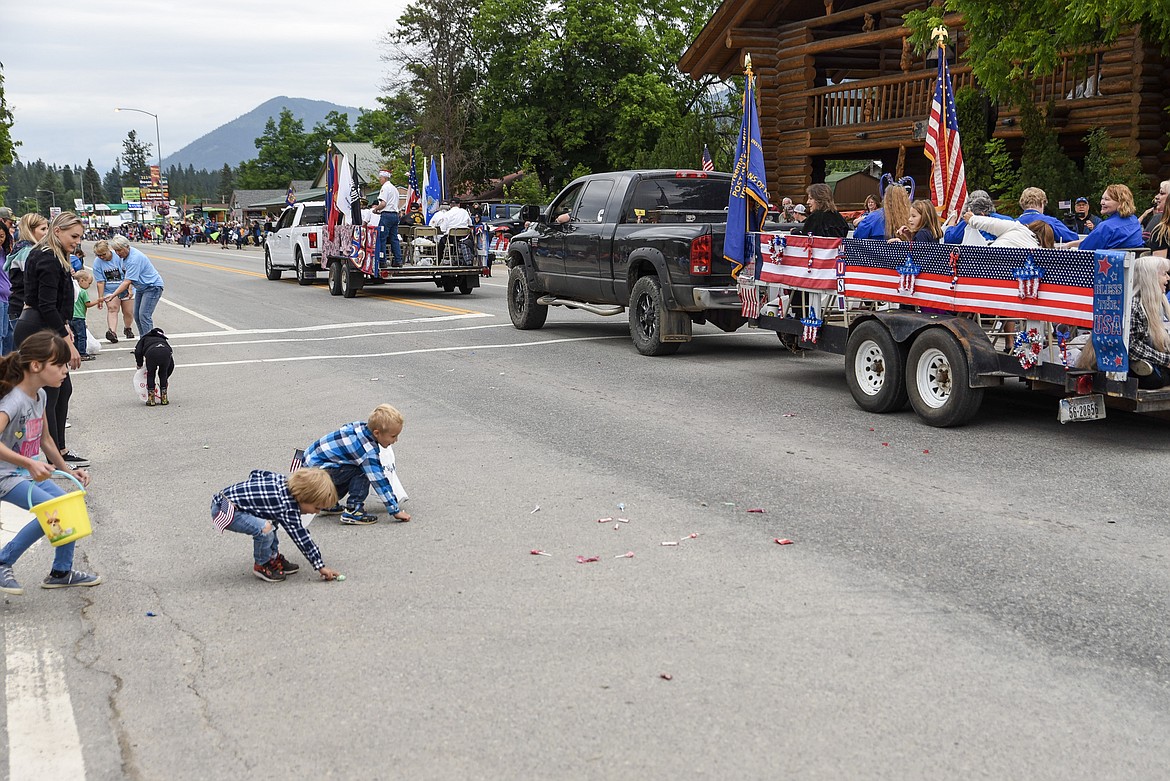Children scramble for candy thrown from the Troy VFW Post 5514 Auxiliary&#146;s float during the 4th of July Parade for Troy&#146;s Old Fashioned 4th of July Thursday. (Ben Kibbey/The Western News)