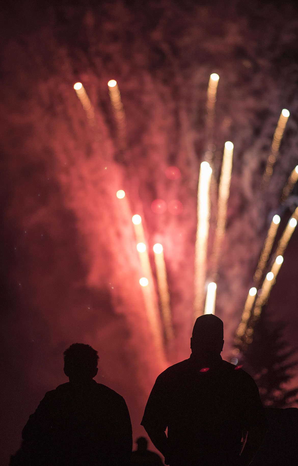 Onlooker at Troy's Old Fashioned 4th of July watch fireworks explode during a show Thursday night in Troy. (Luke Hollister/The Western News)