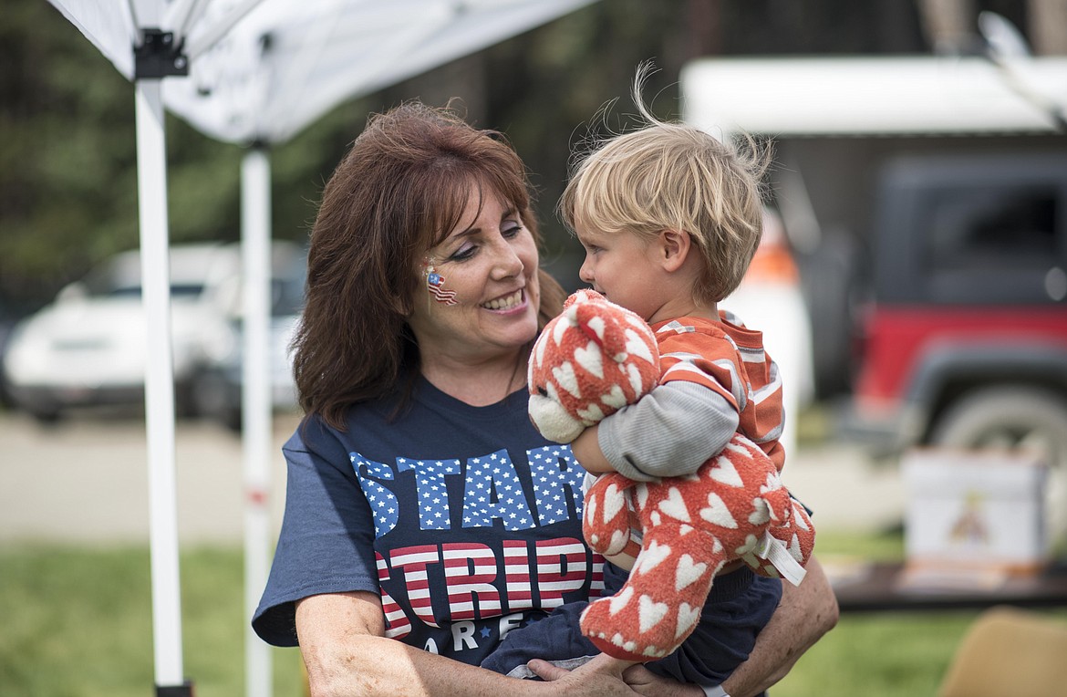 Incoming Yaak School teacher Sabre Alderete, left, hangs out with a future student, Atticus Vick, during a craft fair in the Yaak, Saturday. (Luke Hollister/The Western News)