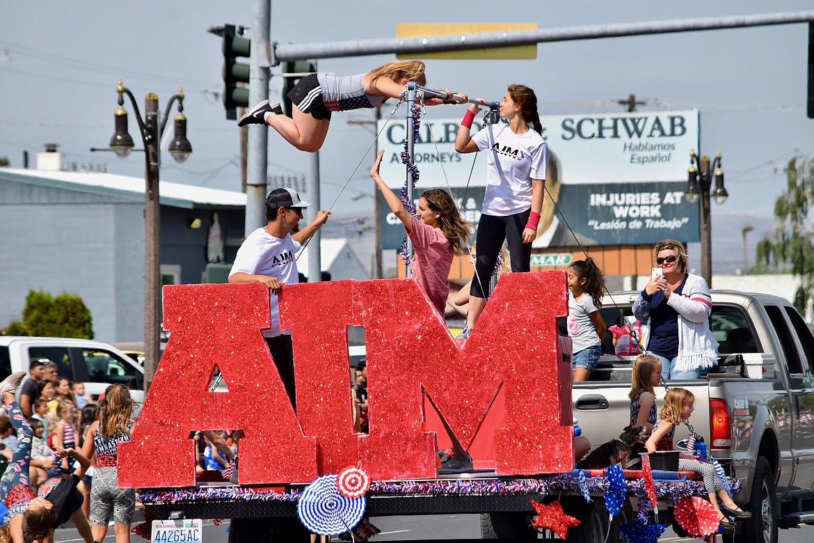 Charles H. Featherstone/Sun Tribune
Gymnasts with AIM Gymnastics perform during the parade.