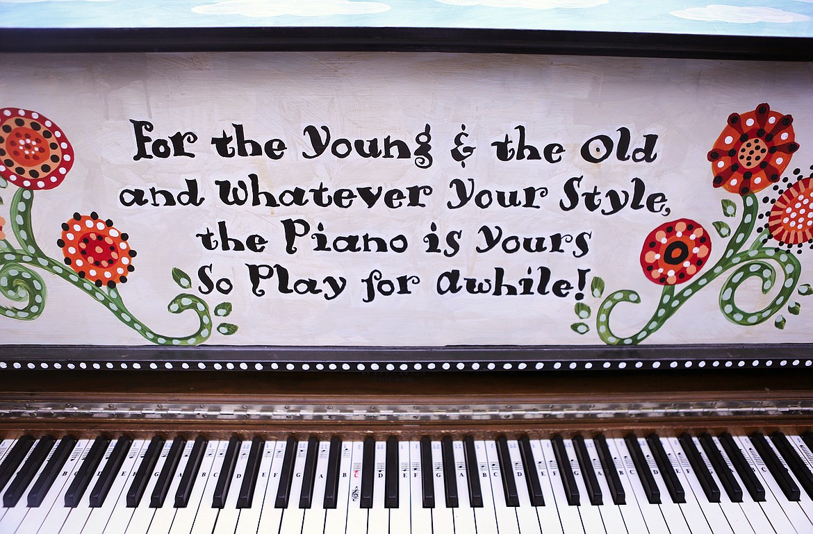 Scripted wording on the Bigfork Art and Cultural Center's public piano invites passersby to stop and play for a while. (Mackenzie Reiss/Daily Inter Lake)
