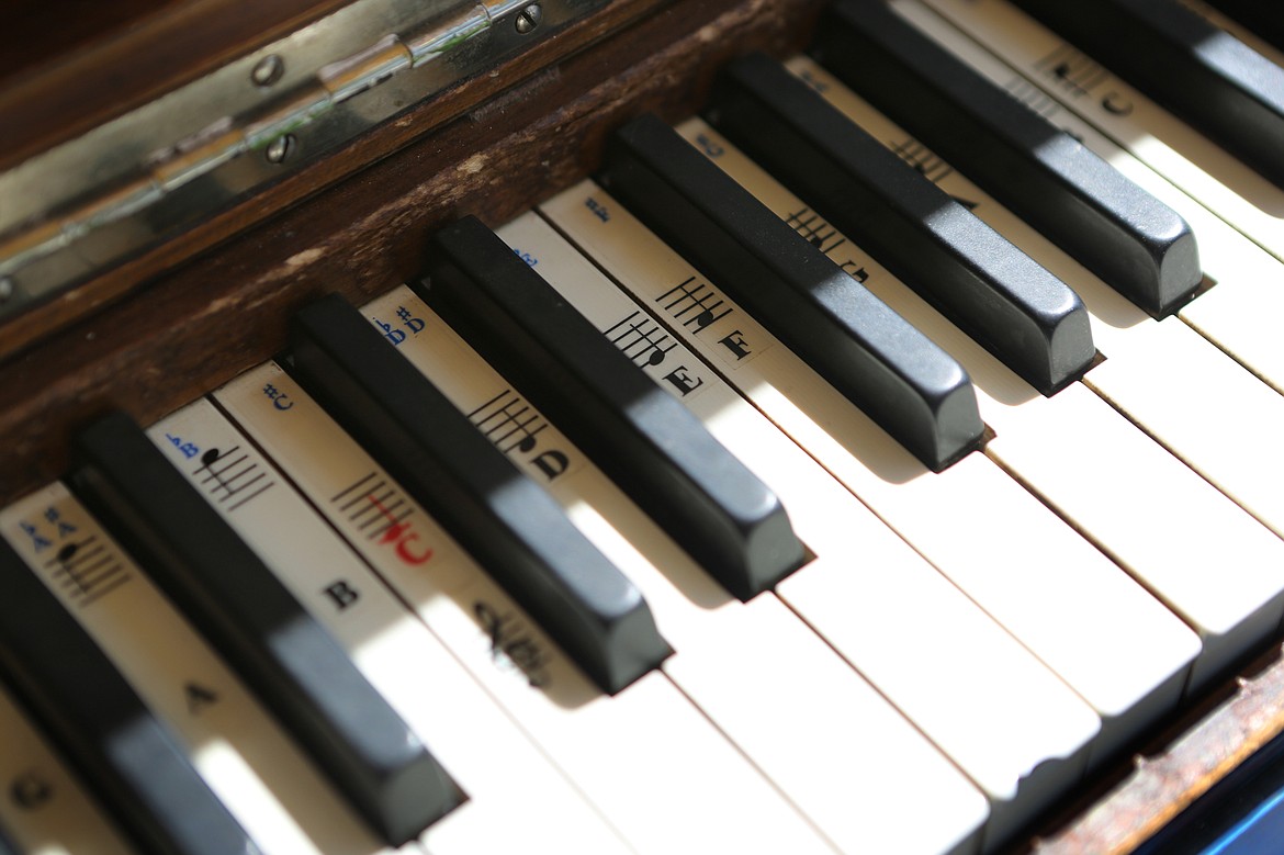 Donated note stickers adorn the keys of the Bigfork Art and Cultural Center's public piano. The piano is available for playing during the center's open hours from 11 a.m. to 5 p.m. Tuesday through Saturday. (Mackenzie Reiss/Daily Inter Lake)