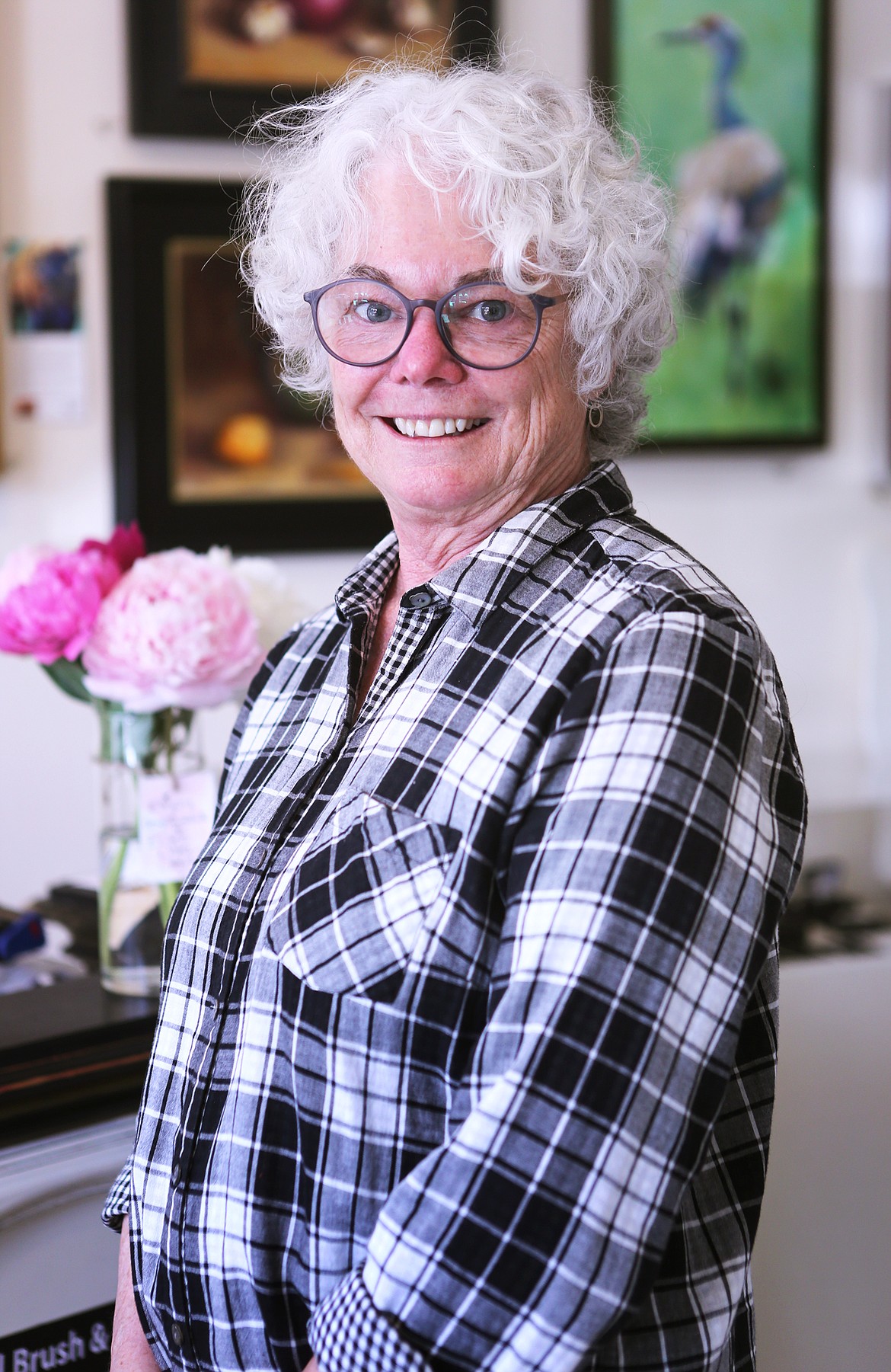 BIgfork artist Jill Gotschalk is pictured at the Persimmon Gallery in downtown Bigfork on June 19. She donated her time and talents last winter to paint the Bigfork Art and Cultural Center's street piano. She used colorful acrylic paints to create a floral theme, topped by a protective coating to protect the instrument from the elements. (Mackenzie Reiss/Daily Inter Lake)