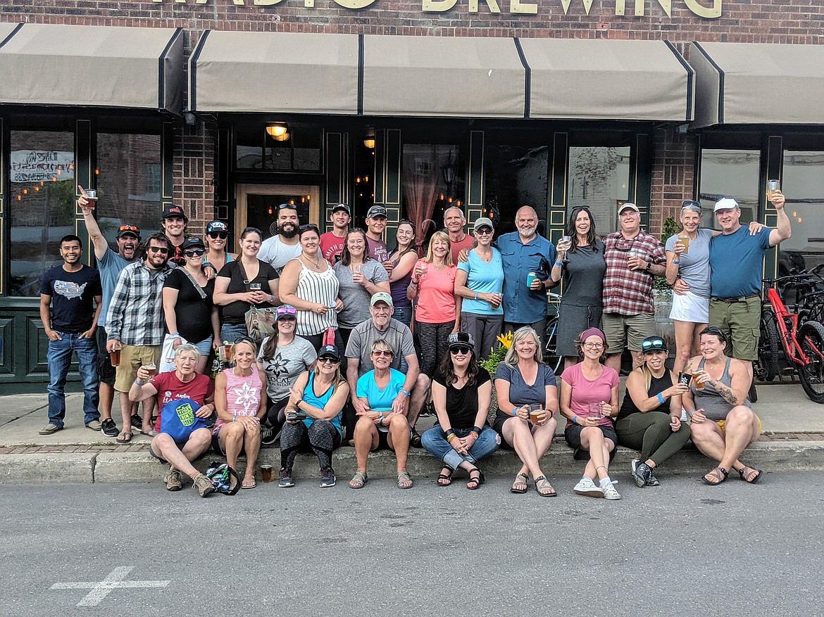 Photo by CHANSE WATSON
This year’s Kegs and Kickstands finishers pose in front of Radio Brewing on Saturday. Radio Brewing was the final stop on the 12-destination route and hosted a barbecue where the raffle winners were announced.