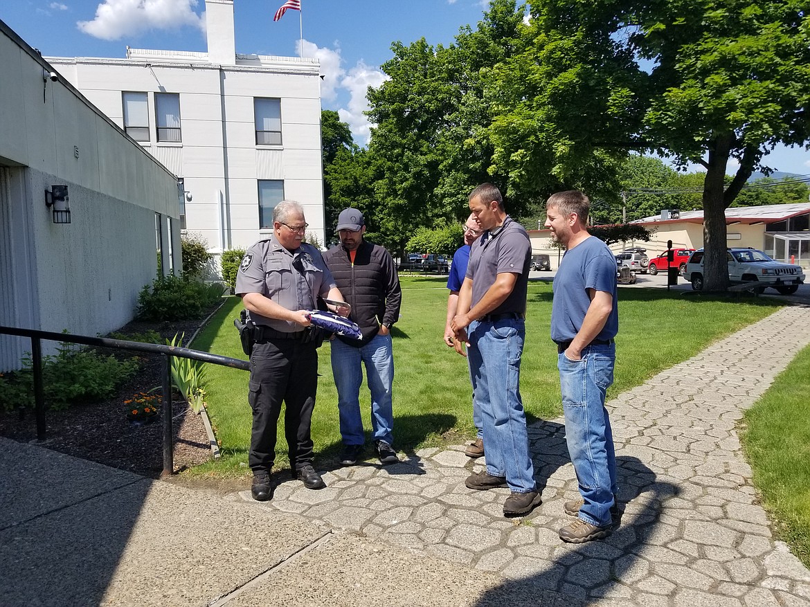 Boundary County Sheriff Dave Kramer shows the new plaque to representatives of the Idaho Forest Group.

Photos by MANDI BATEMAN