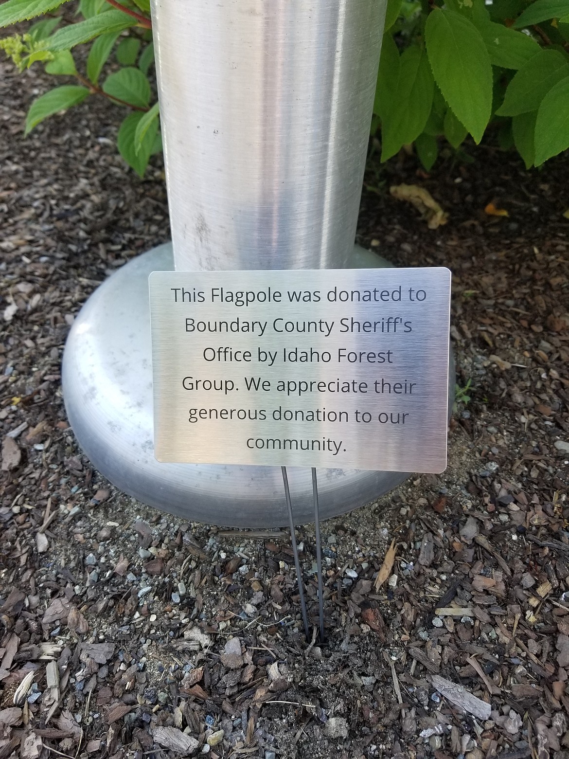 The new plaque thanking the Idaho Forest Group sits at the base of the flagpole that they donated to the sheriff&#146;s office in 2017.