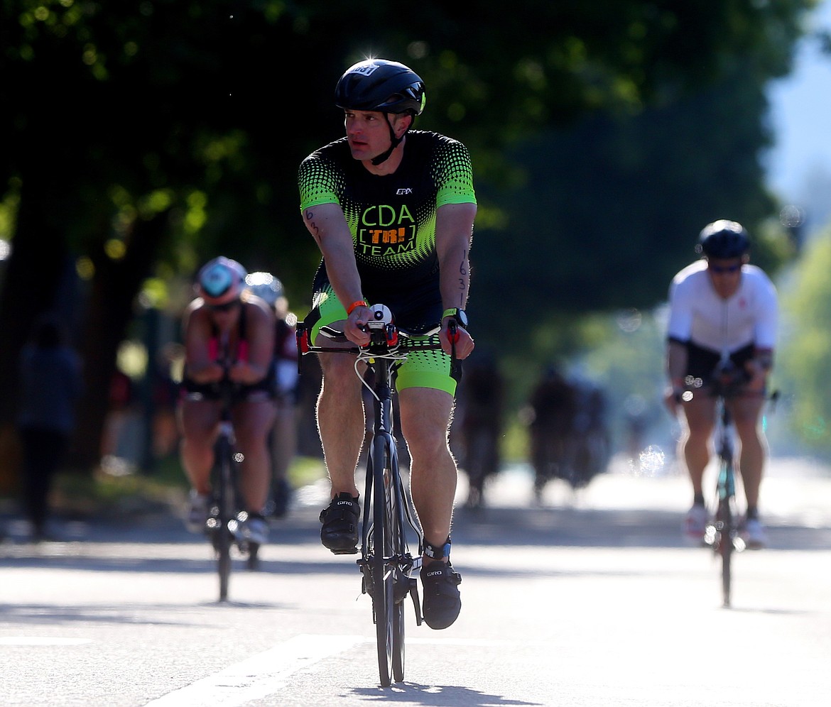 Bret Spencer, of Coeur d&#146;Alene, competes in the bike portion of Ironman 70.3 Coeur d&#146;Alene on Sunday. Spencer crossed the finish line with a time of 5 hours, 55 minutes and 24 seconds. (LOREN BENOIT/Press)