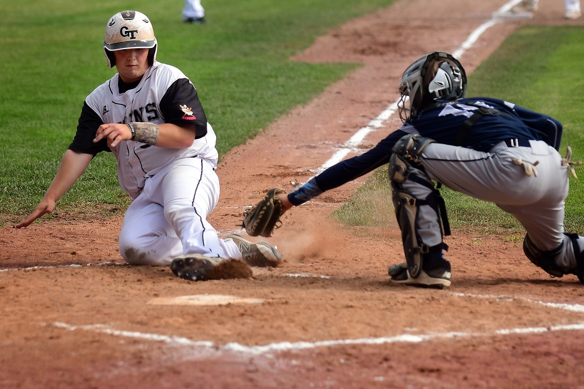 Glacier Twins' Austyn Andrachick slides under the tag to score. (Jeremy Weber/Hungry Horse News)