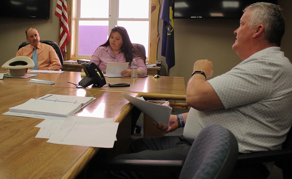 From left, County Commissioner Roman Zylawy, County Attorney Ellen Donohue and CCCS CEO Mike Thatcher chat about the Mineral County jail closure at a public meeting on Tuesday, June 25. (Maggie Dresser/Mineral Independent)