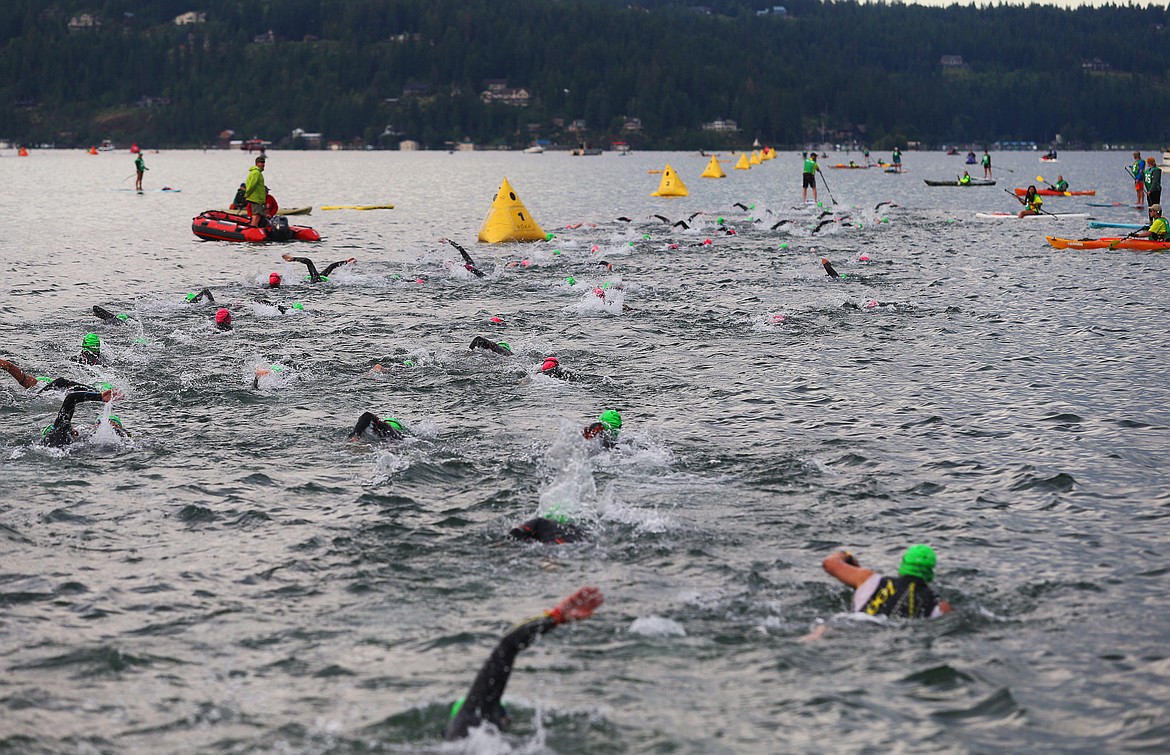 Athletes begin their swim from City Beach during Ironman 70.3 Coeur d&#146;Alene.